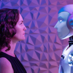 A woman and a humanoid robot face each other, illuminated by purple and blue light