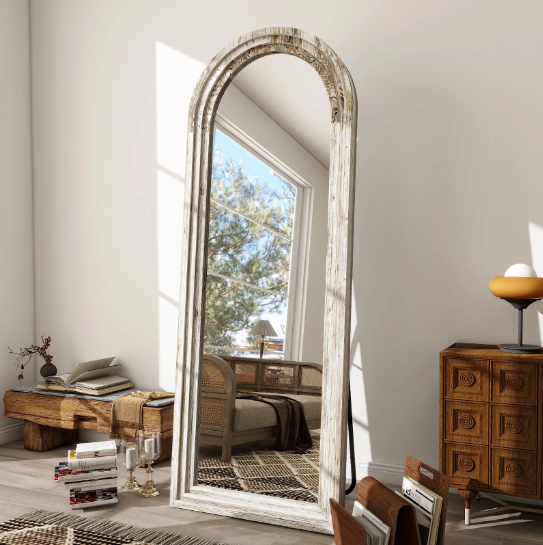 "Arched full-length floor mirror with distressed white wood frame"