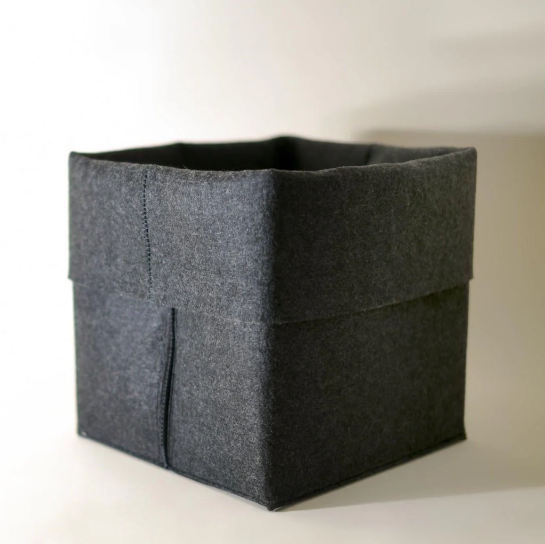 Dark gray felt storage bin or SortJoy The Flex Bin, square shape, for home organization.