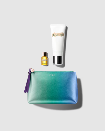 A flat lay image of La Mer skincare products and a cosmetic bag.