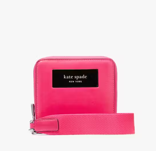 A pink Kate Spade Label Small Compact Webbed Wristlet.