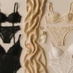 Flat lay of four Nasty Gal lingerie sets including a black lace bodysuit, white lace cutout lingerie set, embroidered daisy lingerie set, and sheer black lace set on a soft neutral background.